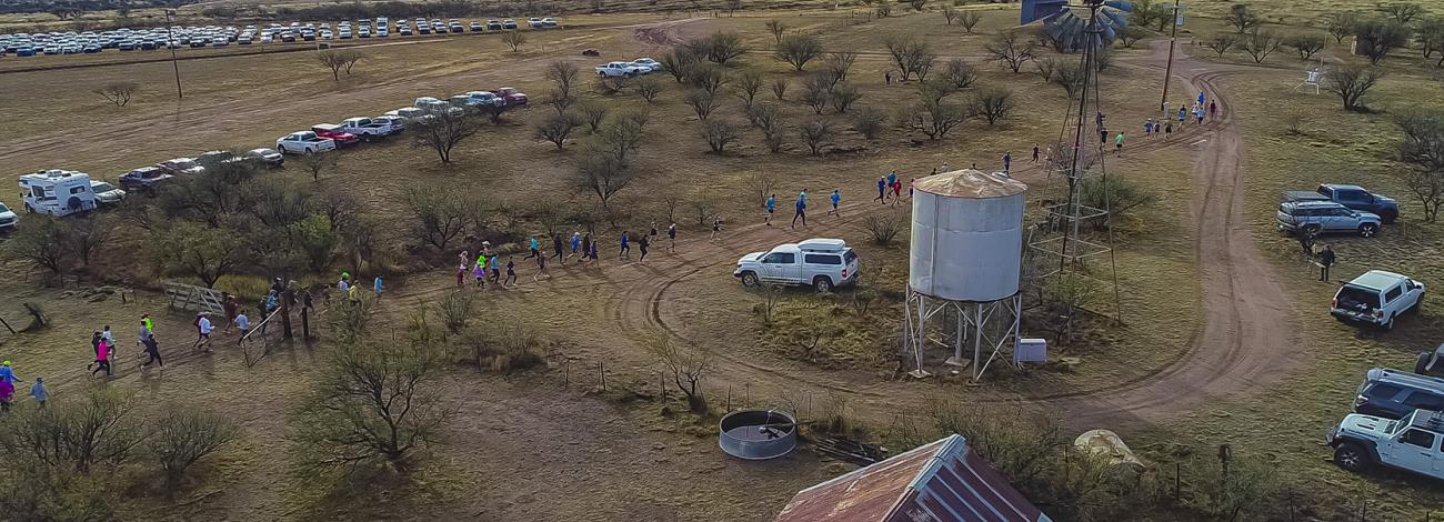 Runners navigate the race course that passes by Empire Ranch structures like a windmill