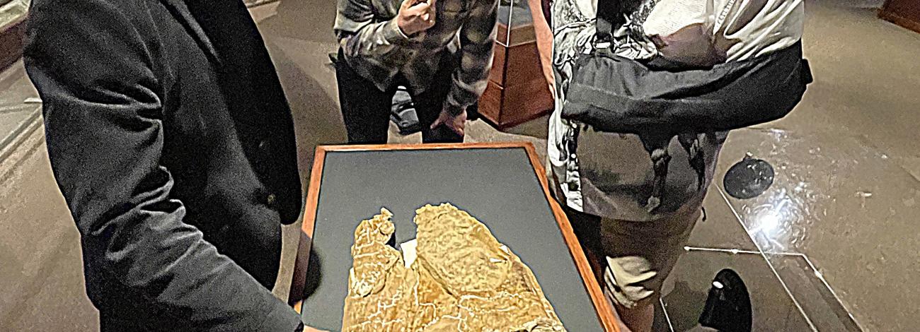 Curator of Paleontology John Scanella, Paleontology Lab and Field Manager Lee Hall, and Senior Director of Exhibitions and Planetarium Scott Williams discuss tooth gouges on an Edmontosaurus skull on display at the Museum of the Rockies Hall of Horns and Teeth. The gentlemen were on hand to crack open the display case for some close up photography on a recent visit by the DOI/BLM.