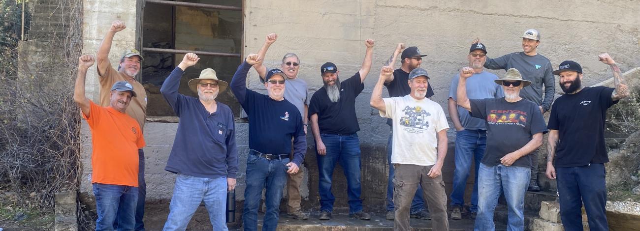 Volunteer group raise arms in celebration of completing the clean up.