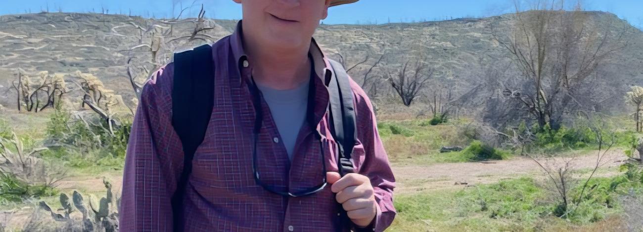 A man wears a wide-brimmed hat