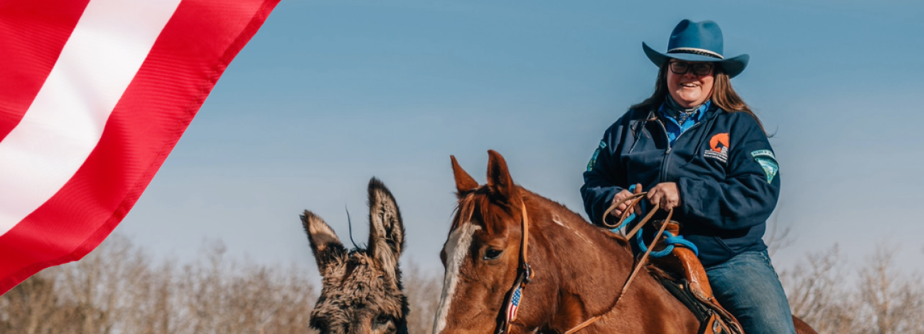 Photo of woman sitting on a brown horse with a burro next to them. The image has graphics of the American flag in the top left and bottom right photo with a textbox that has date and location of a wild horse adoption in Colorado