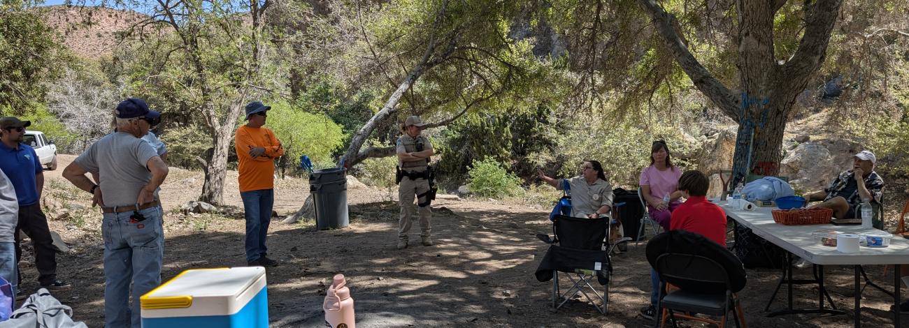 Volunteers meet in a loose circle to plan future restoration to the site.
