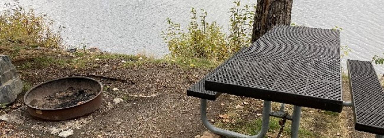 Image of lakeside picnic table and fire ring