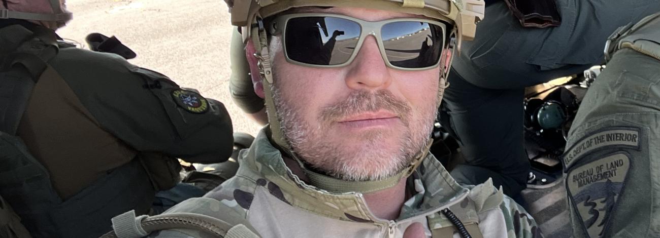 A close up of a man in uniform giving a thumbs up.