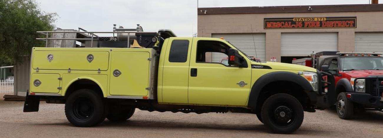 Wildland fire engine in front of fire department.
