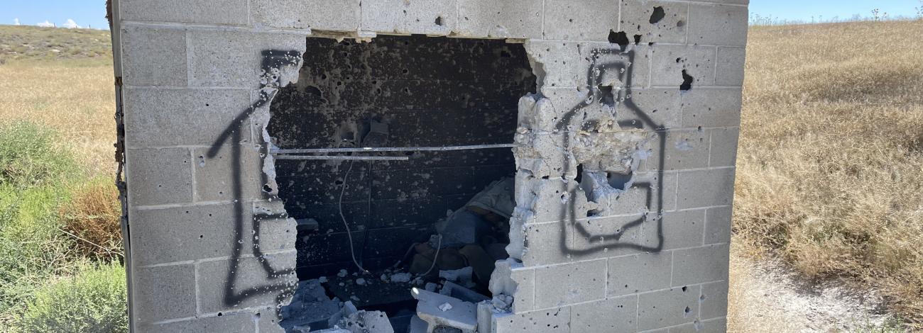 Image of vandalized cement pumphouse
