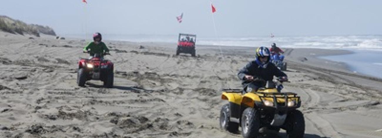Off Highway Vehicles on a ocean beach.