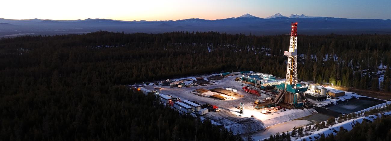 Geothermal rig with mountain range in the background