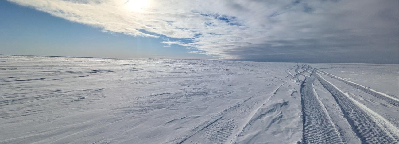 Ice road on snow packed landscape of the National Petroleum reserve in Alaska in winter.
