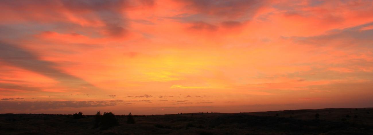 photo of a vivid orange sunset over landscape