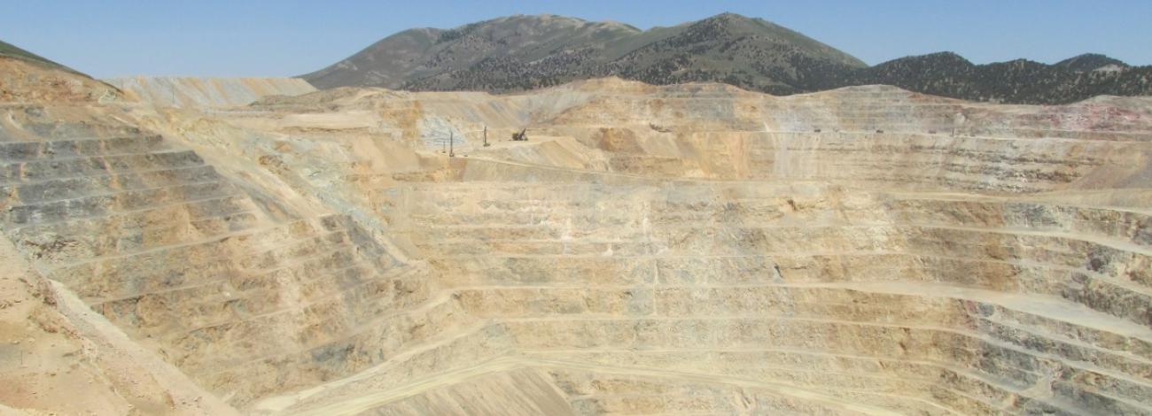 Inside of a mining pit with mountains in the background