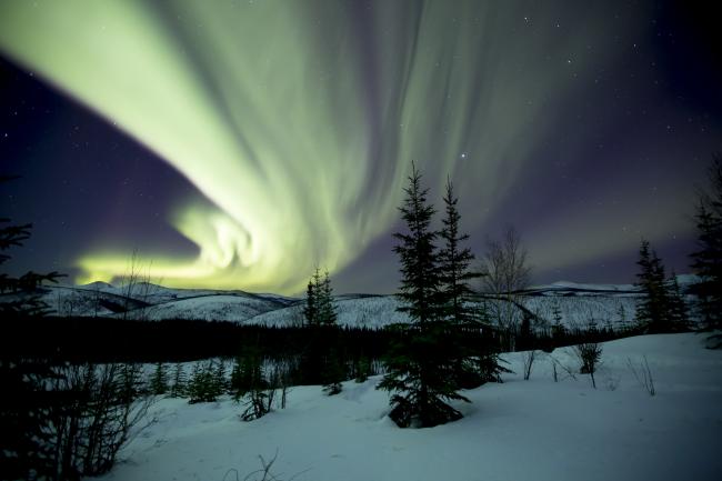northern lights over a snowy landscape