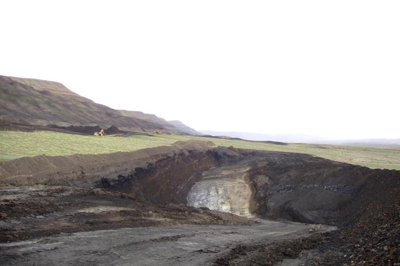 An area mined for bentonite with gently sloping hills in the background.