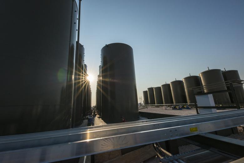 The sun shines through storage tanks at an oil pipeline system in New Mexico.