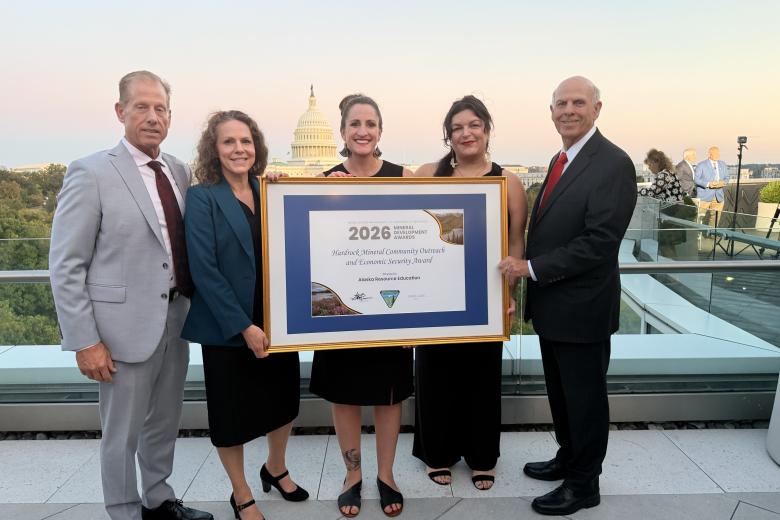 Left to right standing on roof to in Washington, D.C: Lanny Erdos, Tina Roberts-Ashby, two representatives from the Alaska Resource Education holding their framed award, and Stevan Pearce.
