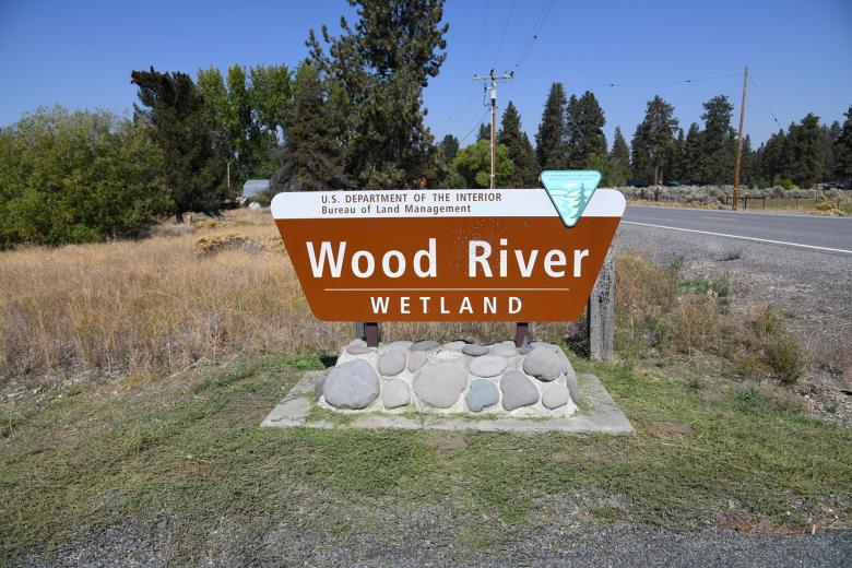 Sign for the Bureau of Land Management Wood River Wetland along a roadside.