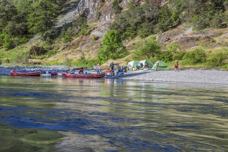 group of rogue boaters camping on a rocky shoreline