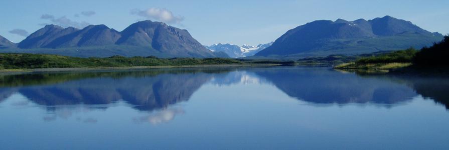 View of Upper Tangle Lake north toward Landmark Gap with surrounding mountains reflecting in the water