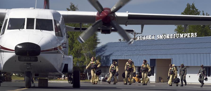 Alaska smokejumpers walking to a plane