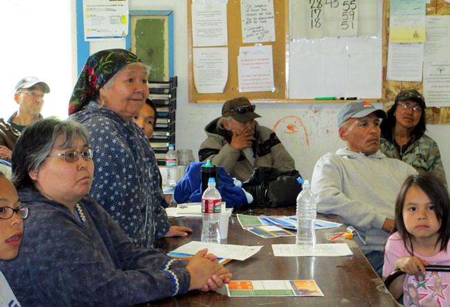 Lower Kalskag tribal members sitting in meeting with one female elder sharing concerns about the Red Devil Mine project during the tribe's 2015 Annual Tribal Gathering.