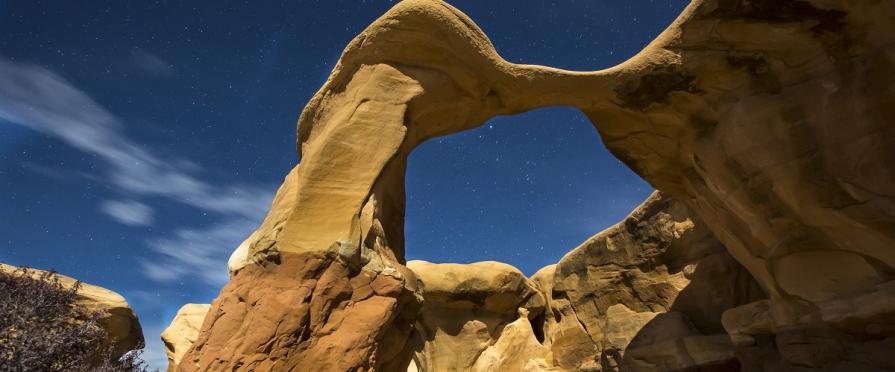 unique natural sandstone arch with blue sky in the background