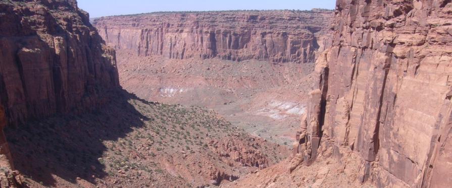 Aerial view into narrow, sheer-walled, meandering canyons 600 to 1,000 feet deep