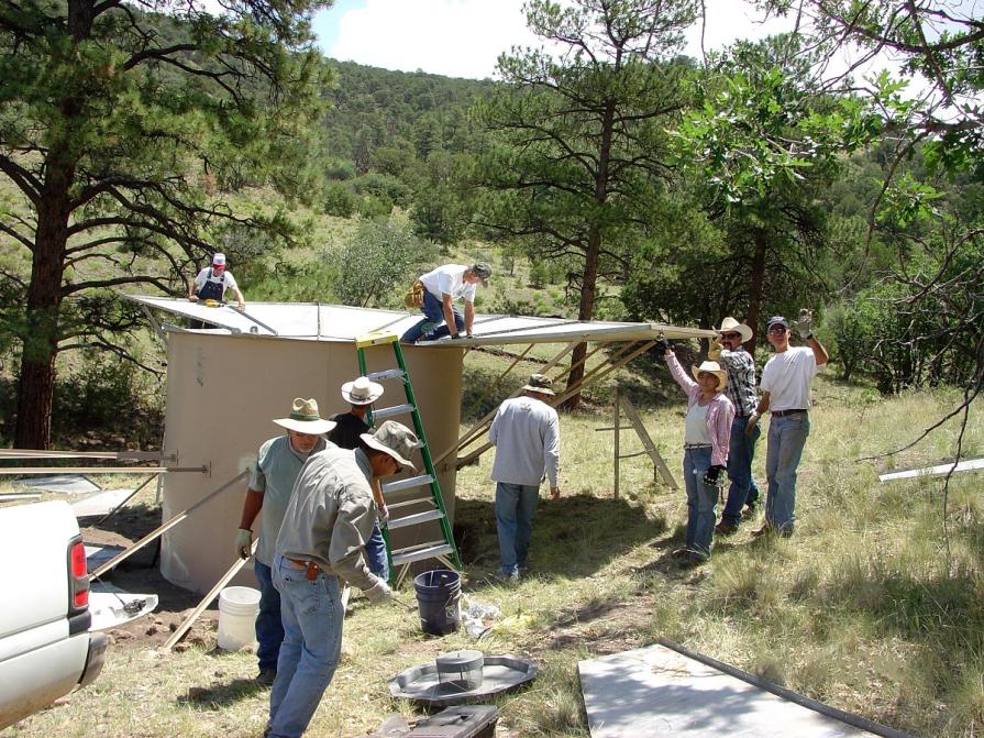The BLM working with the New Mexico Department of Game and Fish, National Wild Turkey Federation, and members of the public constructing a watering unit near Palona Mountain.
