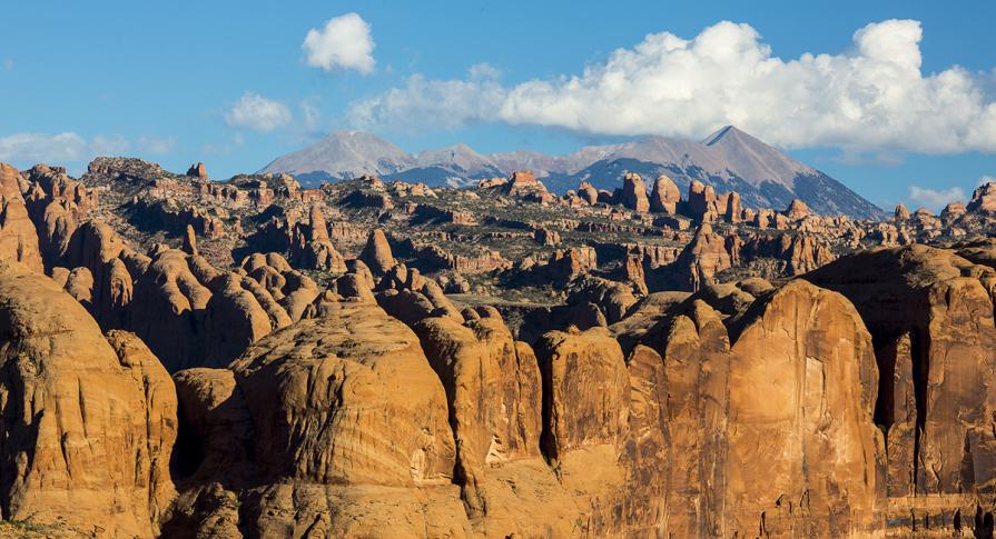 The La Sal Mountains rise up behind the Behind the Rocks Wilderness Study Area. 