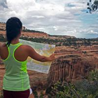 A woman looks at her map in Cedar Mesa.
