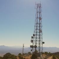 Communication tower centered against the sun atop of Keystone Peak near Tuscon Arizona