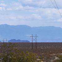 Photo of a powerline crossing desert terrain in Nevada.