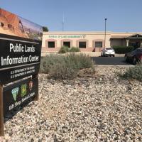 Sign that says Public Lands Information Center with a building in the background that has the words Bureau of Land Management on it