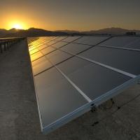 Sun sets over a row of solar panels