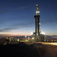 photo of oil rig lit up at night