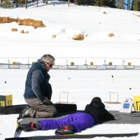 A youth participant learns how to shoot using an electronic rifle during winter adventure day