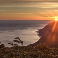 Sunset over mountains and the ocean.