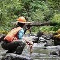 Two BLM employees conduct scientific research in a stream