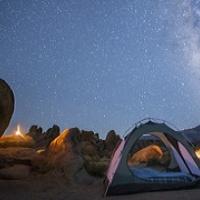 An open tent under a starry sky.