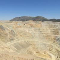 Inside of a mining pit with mountains in the background