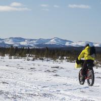 Winter biker biking on the Iditarod National Historic Trail