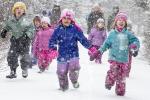 Excited children run through the snow down the trail during a program at the Campbell Creek Science Center.