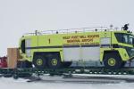 Truck on a trailer in the snow.