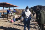 a group of people gathered around a picnic shelter