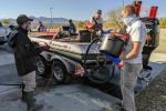 people clean a motor boat on a trailer