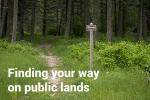 "Finding your way on Public Lands"  Rocky trail goes through green grass and tall trees.
