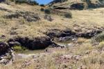 Natural pools surrounded by rocks and brown grass