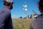 Employees in the field setting up a remote fire camera system.