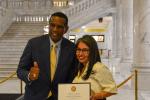 Congressman Burgess Owens and Anayanci pose for a photo with her award. 