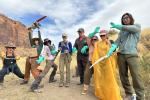 The team highlights tools they use to accomplish the tamarisk removal while keeping themselves and their co-workers safe. Their gloved hands hold chainsaws, folding saws, and lobbers.