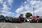 Crews pose in front of seven wildland fire engines from various agencies 